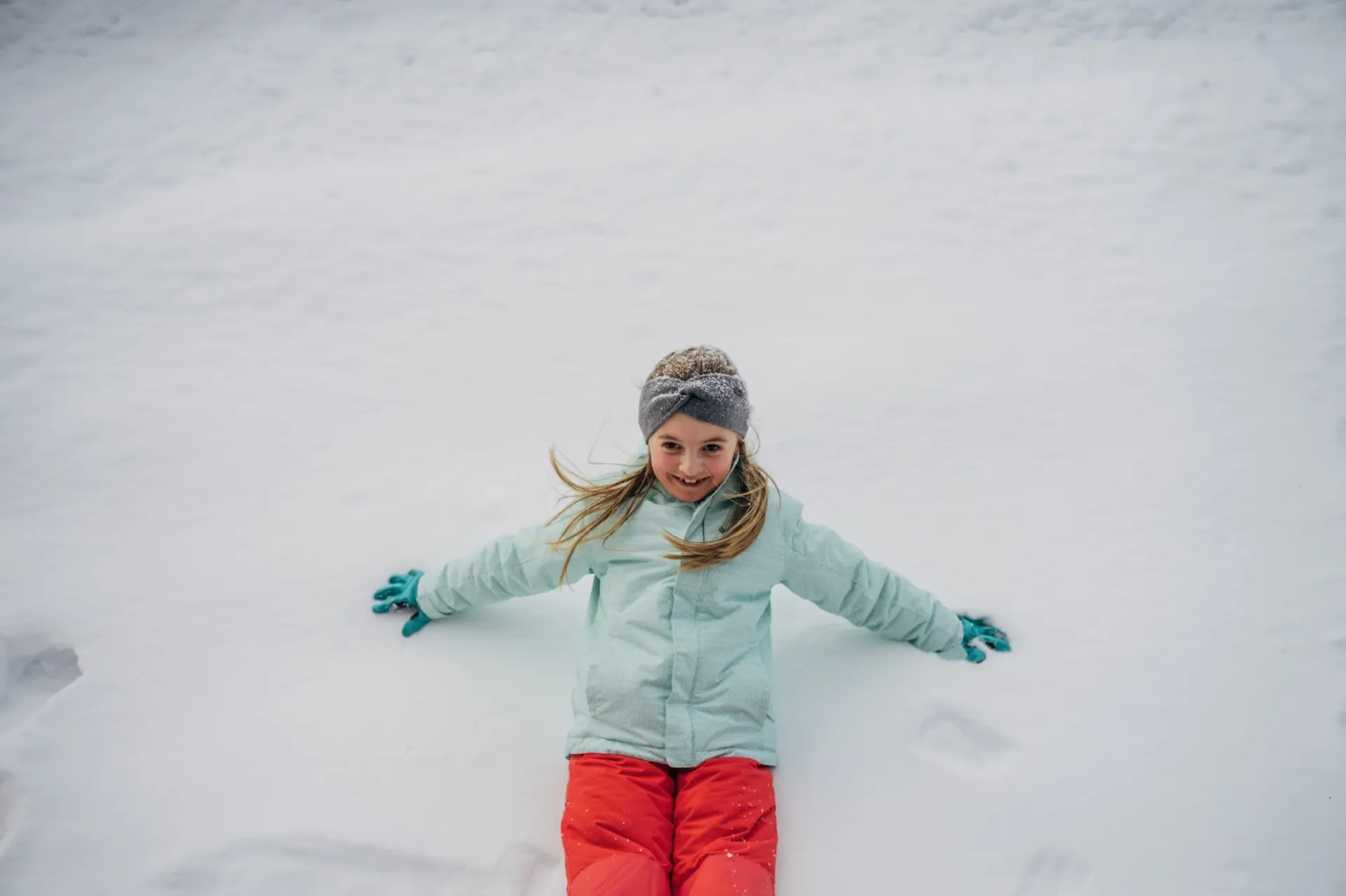Kind macht einen Schneeengel