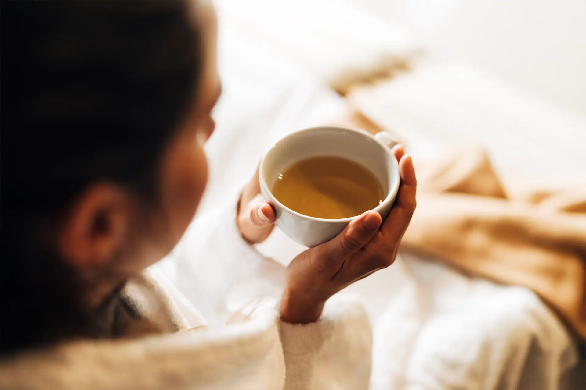 Relaxation - deceleration and mindfulness on vacation with a cup of organic tea in the holiday village.