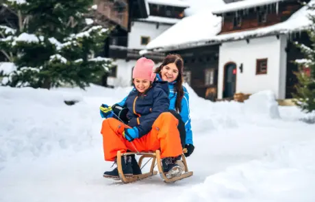 Family Winter Vacation in Carinthia: Children Sledding in Kirchleitn Holiday Village in Bad Kleinkirchheim