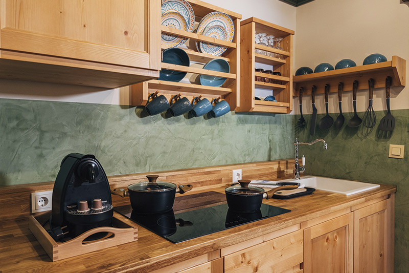 Kirchleitn Apartment Kitchen Fully equipped kitchen in the apartment at Slow Travel Resort Kirchleitn with two pots on the stove.